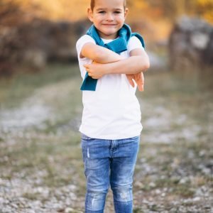 Little handsome boy in field alone