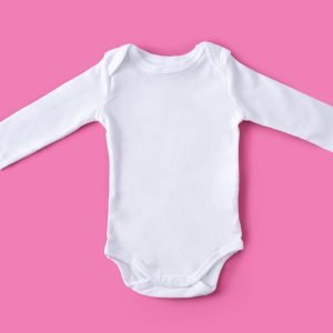 White baby clothes on pink background